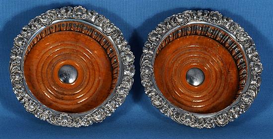 A pair of George IV silver wine coasters, Diameter 6 ¾”/170mm Height 60 Total weight inc bases 19.6ozs/557grs